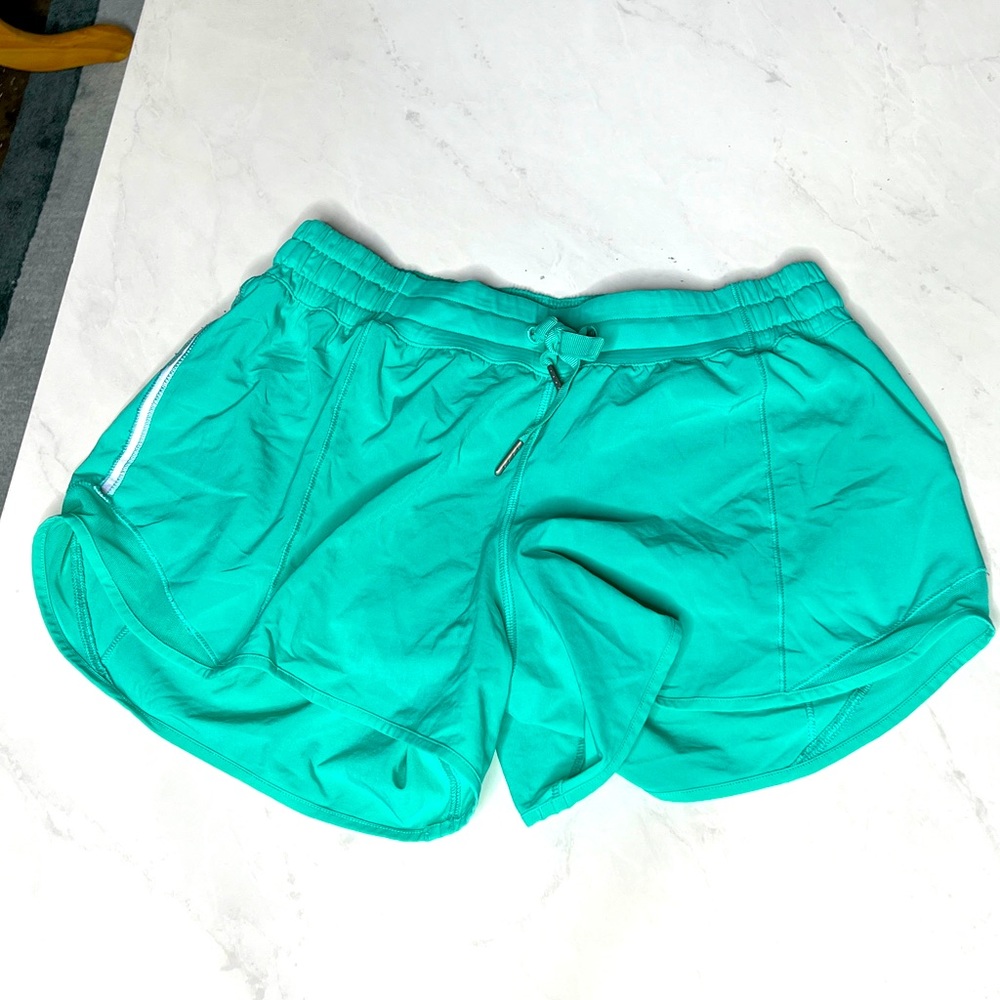 Green Lululemon running shorts and drawstring elastic waistband